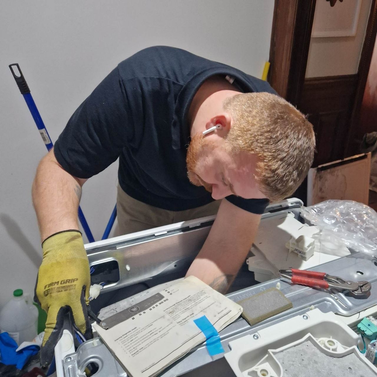 KLIA NY technician diagnosing a residential washing machine